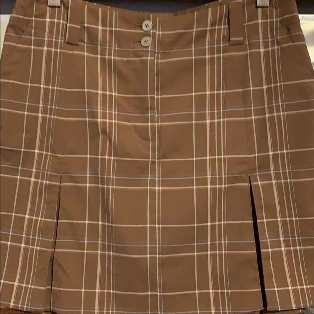 Light brown plaid gulf skirt with kick pleats.